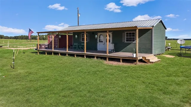 a view of a chair and table in backyard of the house