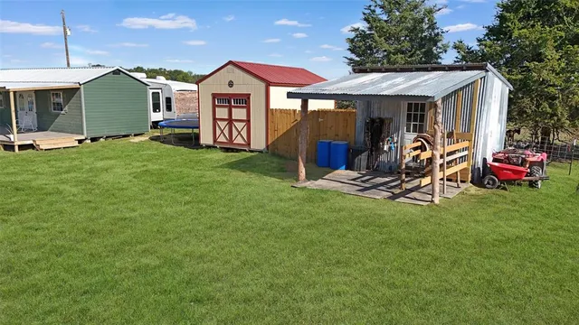 a view of an house with backyard space and deck