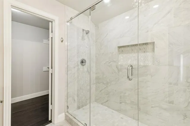 a bathroom with a shower and a sink
