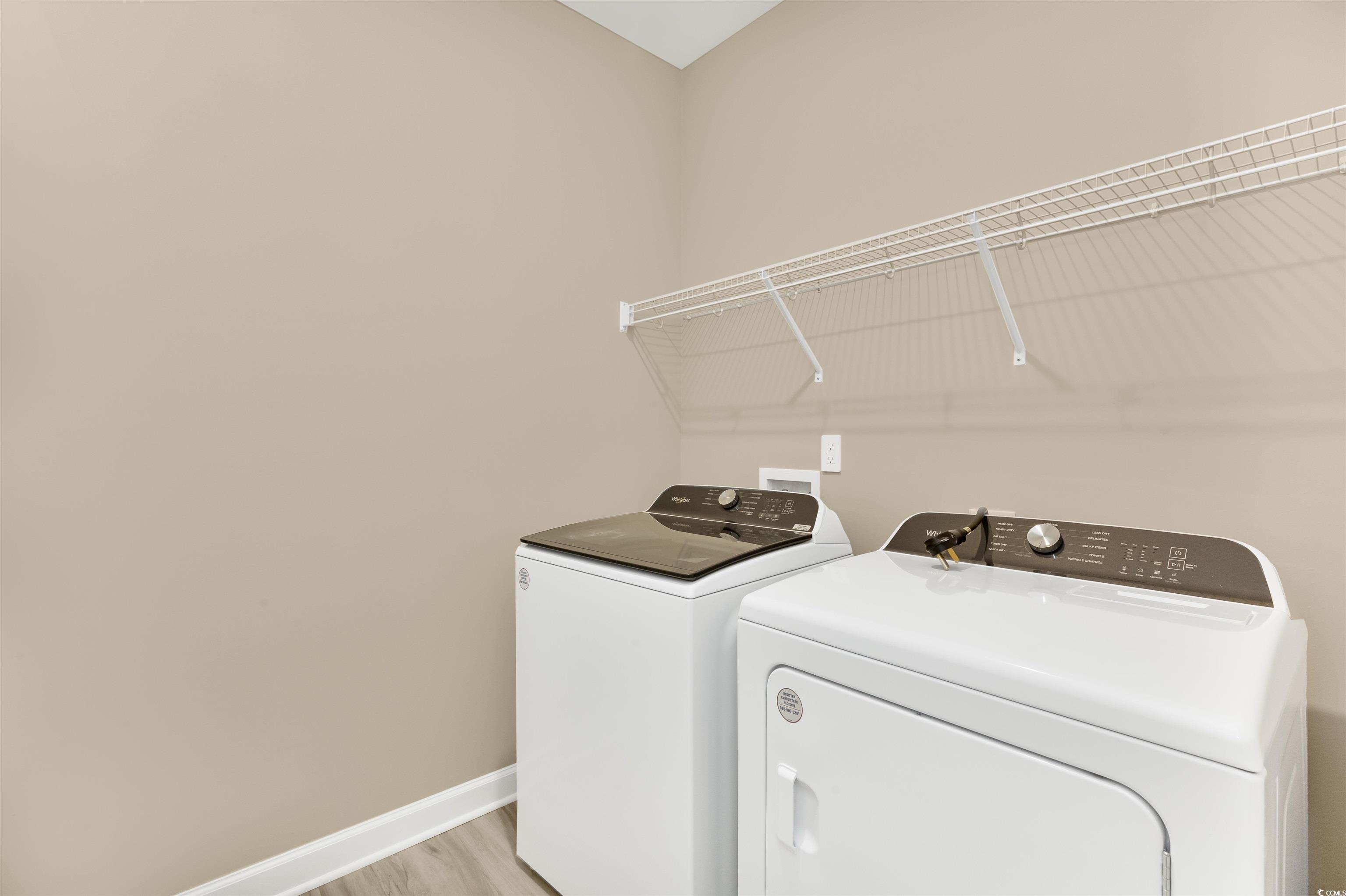 826 Cypress Preserve Circle Longs, SC 29568 - Photo 23 of 27 Washroom featuring light wood finished floors, washer and clothes dryer, laundry area, and baseboards