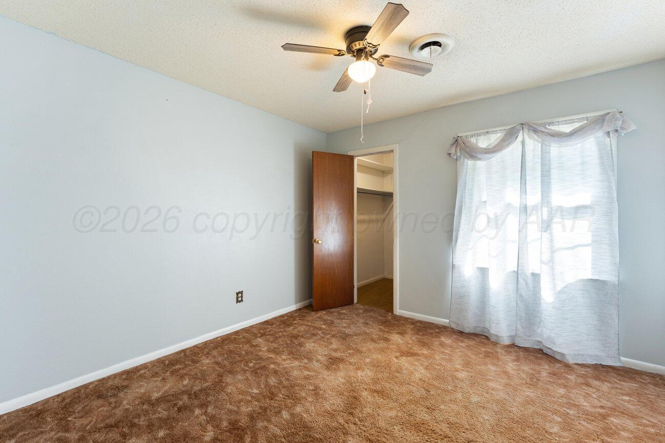 4305 South Bonham Street Amarillo, TX 79110 - Photo 31 of 48 a view of empty room with window and ceiling fan