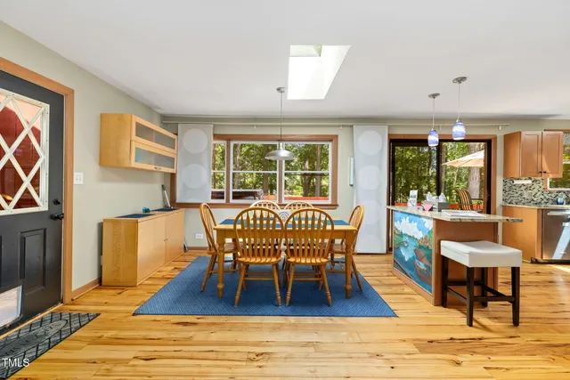 a living room with fireplace furniture and a large window