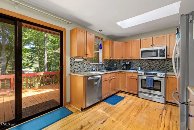 a dining room with furniture a rug and wooden floor