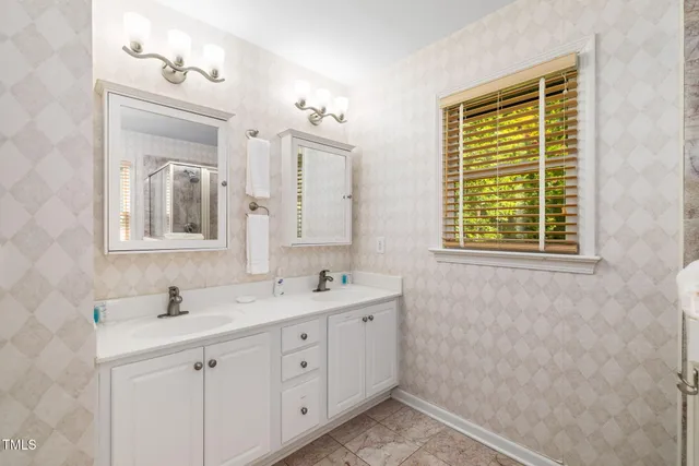 a bathroom with a shower sink and a mirror