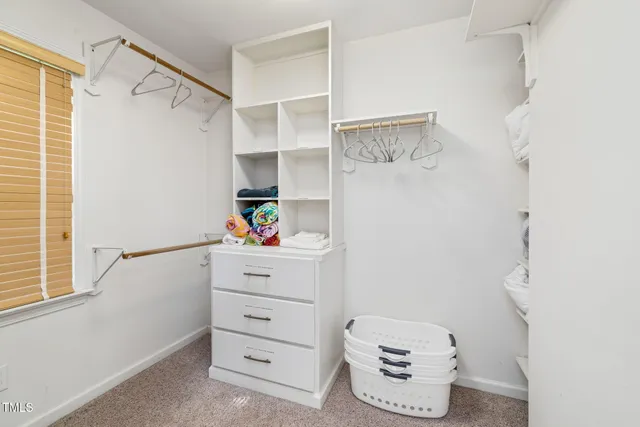 a bathroom with a double vanity sink a mirror and a window