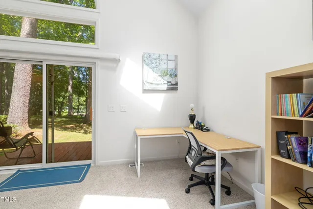 a view of a workspace with furniture and a window
