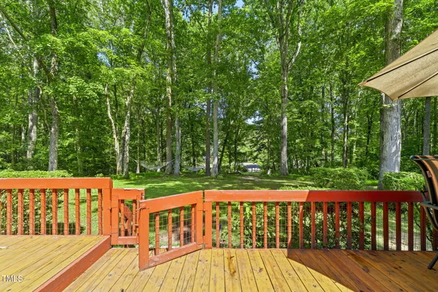 a view of a backyard with large trees