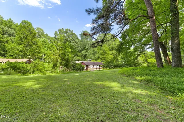 a backyard of a house with a garden and outdoor seating