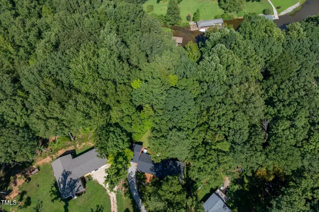 an aerial view of a houses with outdoor space and lake view