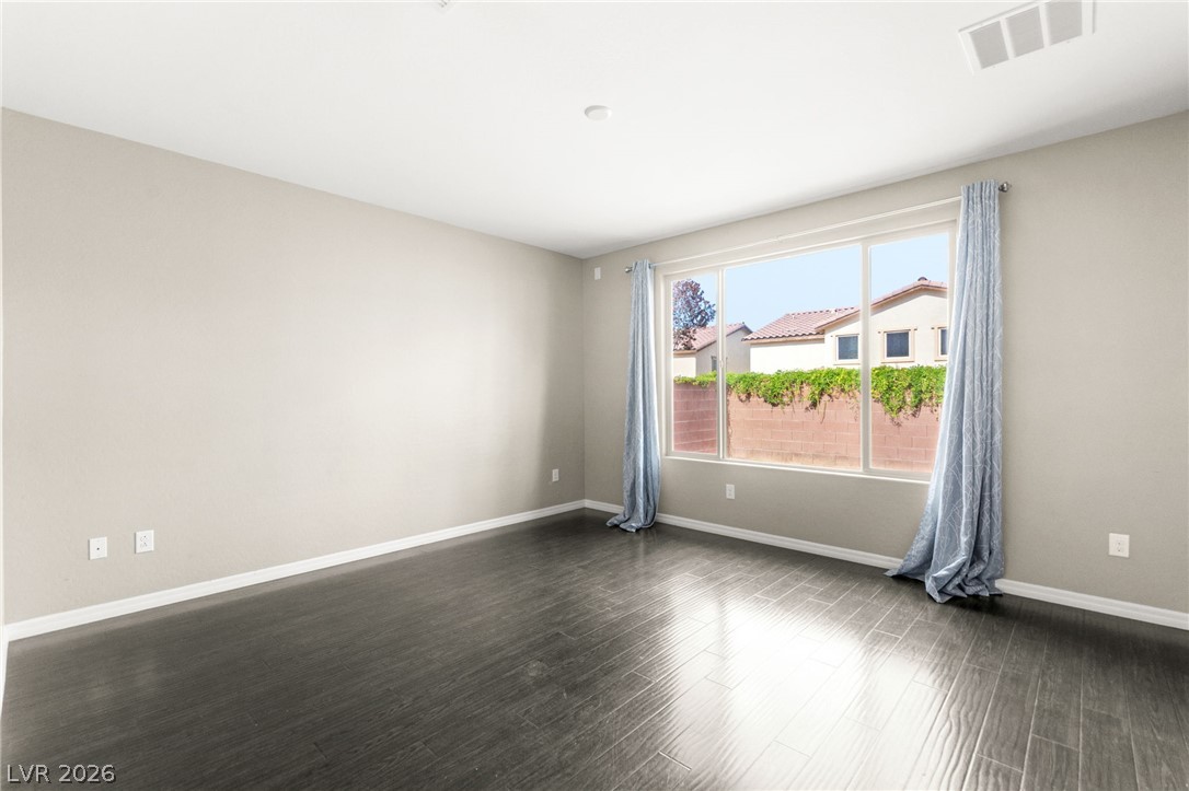 11048 Prairie Grove Road Las Vegas, NV 89179 - Photo 21 of 75 Sun-filled room boasts gleaming dark hardwood flooring and wide windows for abundant natural light.