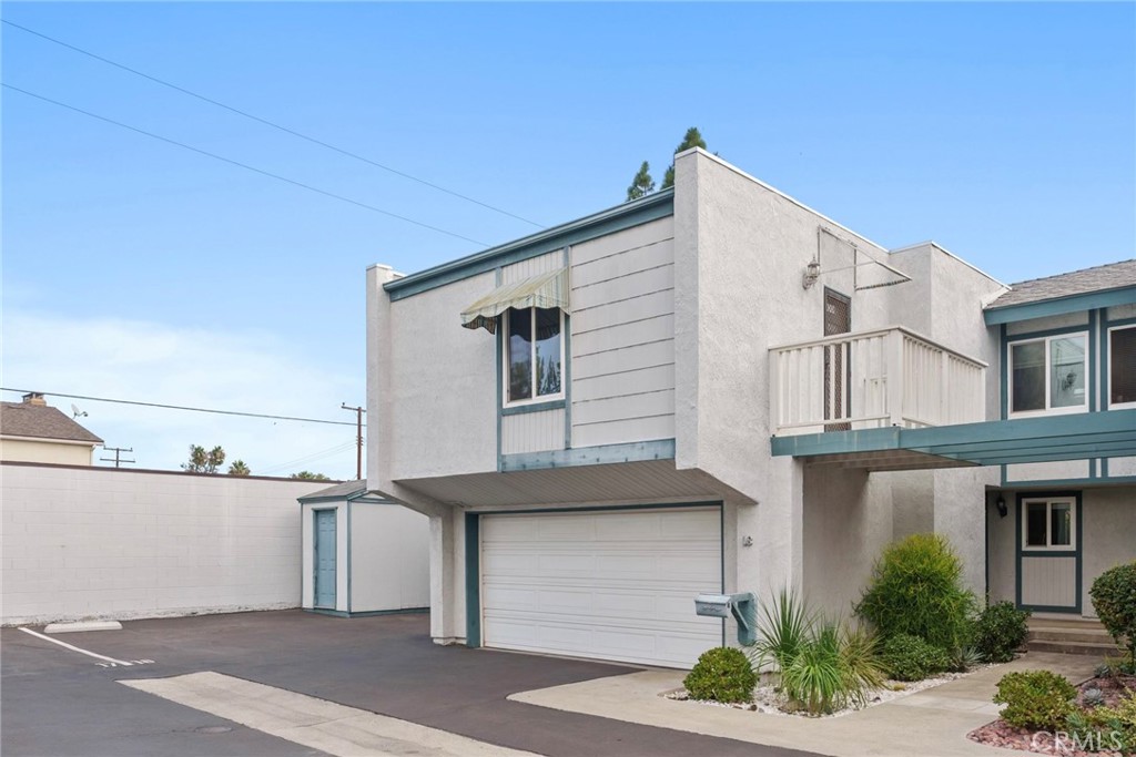 12720 Newport Avenue, Unit 18 Tustin, CA 92780 - Photo 1 of 37 a front view of a house with a garage