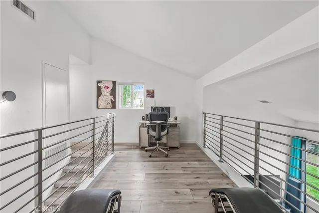 a view of a workspace with furniture and a gate