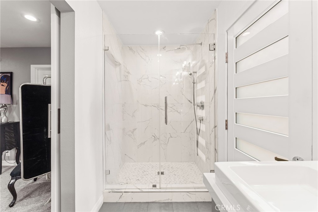 12720 Newport Avenue, Unit 18 Tustin, CA 92780 - Photo 20 of 37 a bathroom with a bathtub and a shower