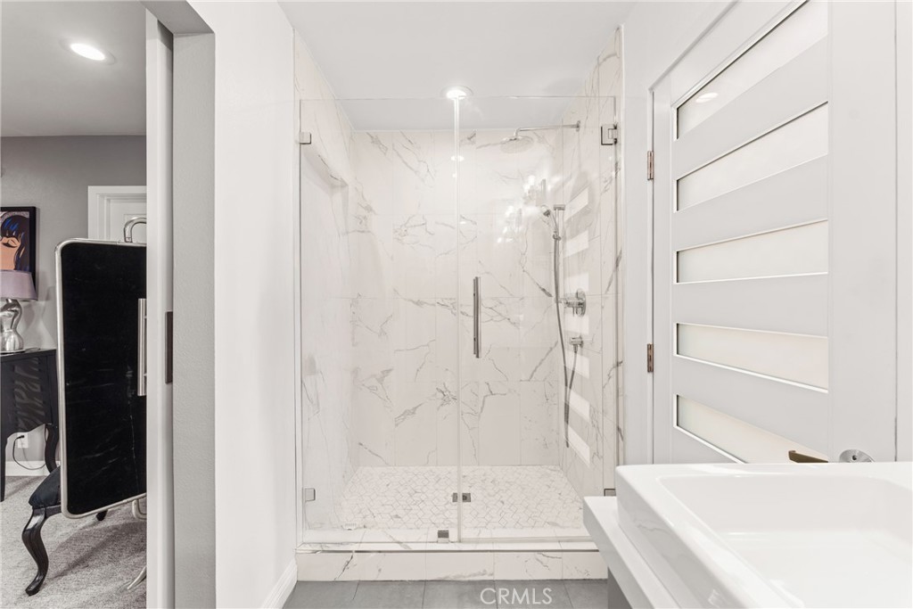 12720 Newport Avenue, Unit 18 Tustin, CA 92780 - Photo 21 of 37 a bathroom with a bathtub and a shower