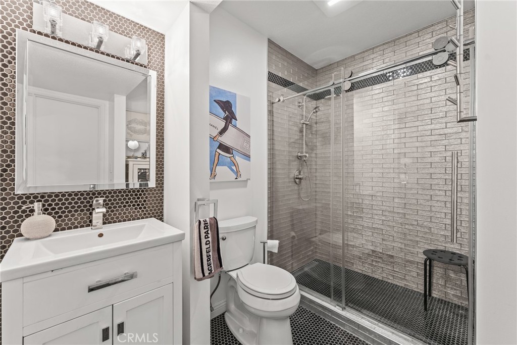 12720 Newport Avenue, Unit 18 Tustin, CA 92780 - Photo 25 of 37 a bathroom with a sink toilet and shower