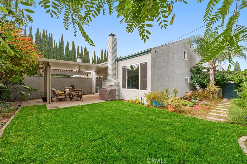 12720 Newport Avenue, Unit 18 Tustin, CA 92780 - Photo 26 of 37 a view of a house with backyard porch and sitting area