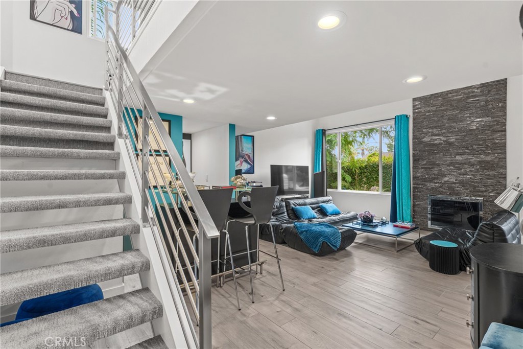 12720 Newport Avenue, Unit 18 Tustin, CA 92780 - Photo 3 of 37 a living room with furniture and a fireplace