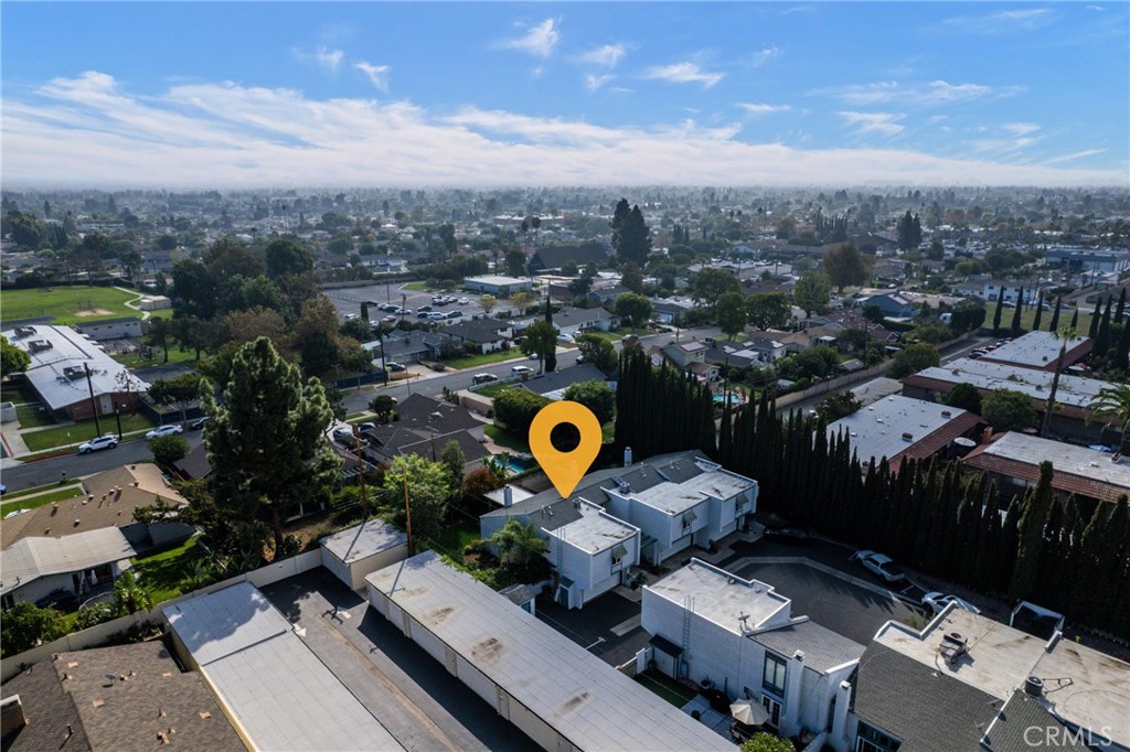 12720 Newport Avenue, Unit 18 Tustin, CA 92780 - Photo 32 of 37 an aerial view of a house with a swimming pool a yard and mountain view