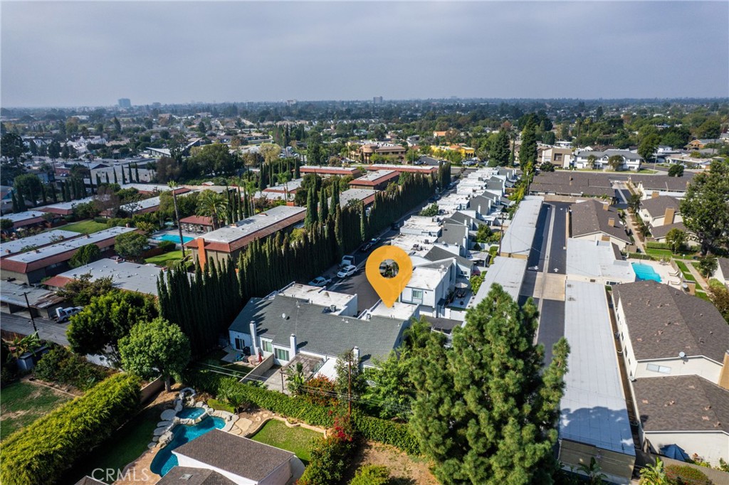 12720 Newport Avenue, Unit 18 Tustin, CA 92780 - Photo 33 of 37 an aerial view of a houses with a swimming pool