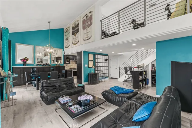 a living room with furniture a rug and kitchen view