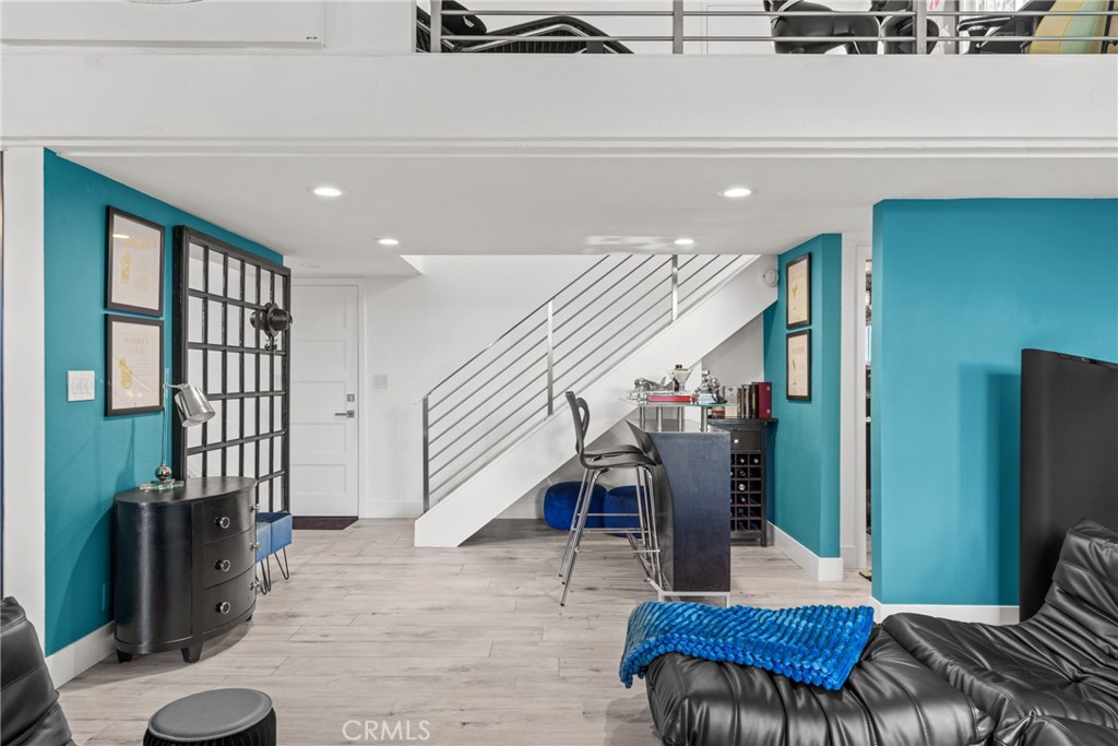 12720 Newport Avenue, Unit 18 Tustin, CA 92780 - Photo 5 of 37 a living room with furniture and wooden floor