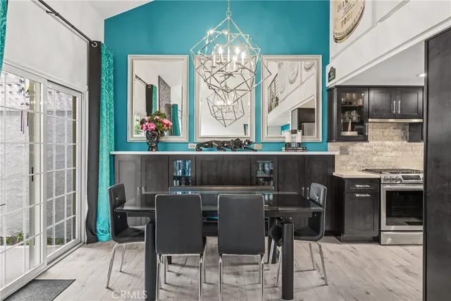 a dining area with a table chairs and a kitchen view