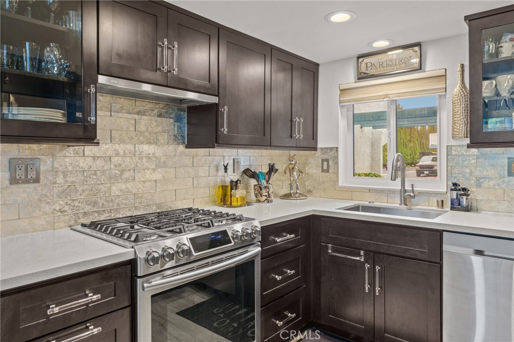 12720 Newport Avenue, Unit 18 Tustin, CA 92780 - Photo 10 of 37 a kitchen with stainless steel appliances granite countertop a sink stove and cabinets
