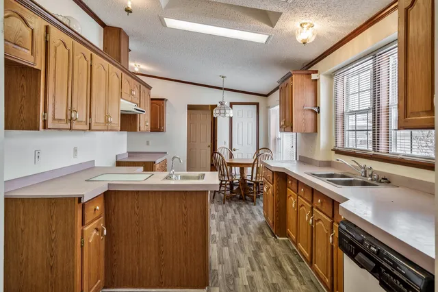 a kitchen with stainless steel appliances granite countertop a sink stove and cabinets
