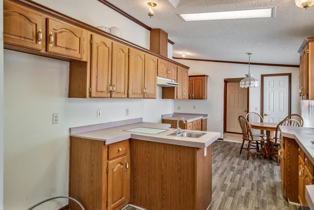 a kitchen with a sink cabinets and a window