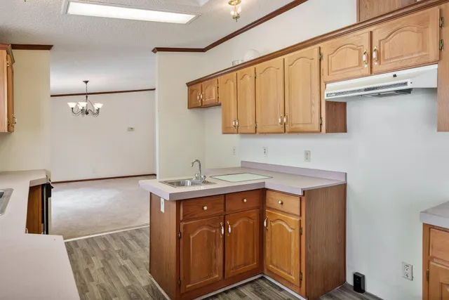 a spacious bedroom with a bed and a chandelier