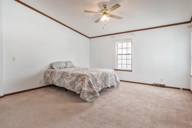 a view of a livingroom with a chandelier fan and a closet