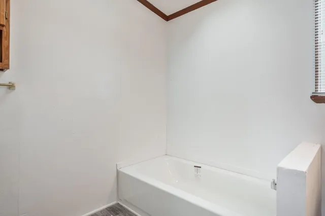 a view of a house with wooden fence