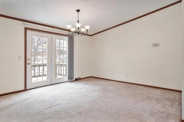 a view of a livingroom with a chandelier fan and a closet