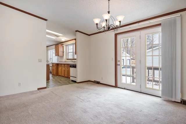 a kitchen with stainless steel appliances granite countertop a kitchen island a stove and a wooden floors