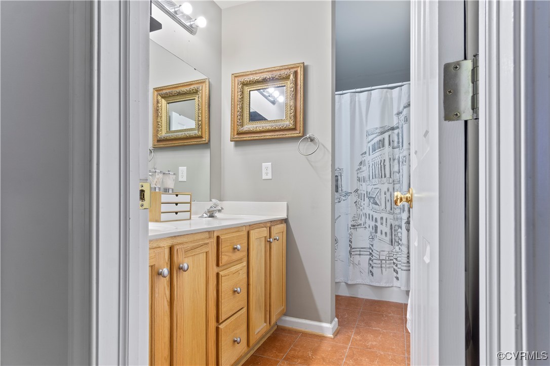 4824 Bristol Circle Williamsburg, VA 23185 - Photo 20 of 36 Bathroom with walk in shower, vanity, and tile pat