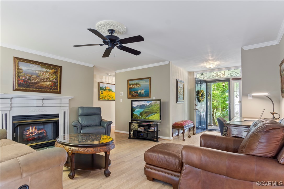 4824 Bristol Circle Williamsburg, VA 23185 - Photo 10 of 36 Living room featuring crown molding, light hardwoo