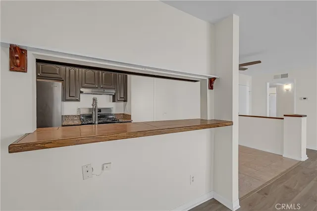 a view of kitchen and refrigerator
