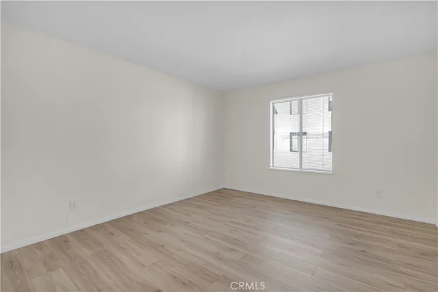 an empty room with wooden floor