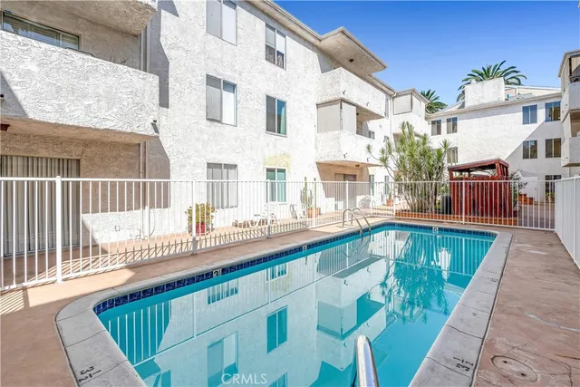 a view of a patio with a table and chairs under an umbrella