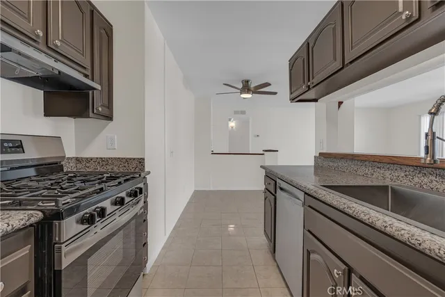 a kitchen with a refrigerator and a stove