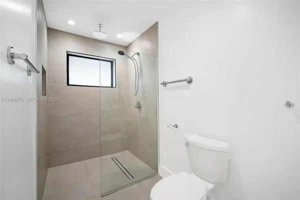 a bathroom with a toilet and a shower