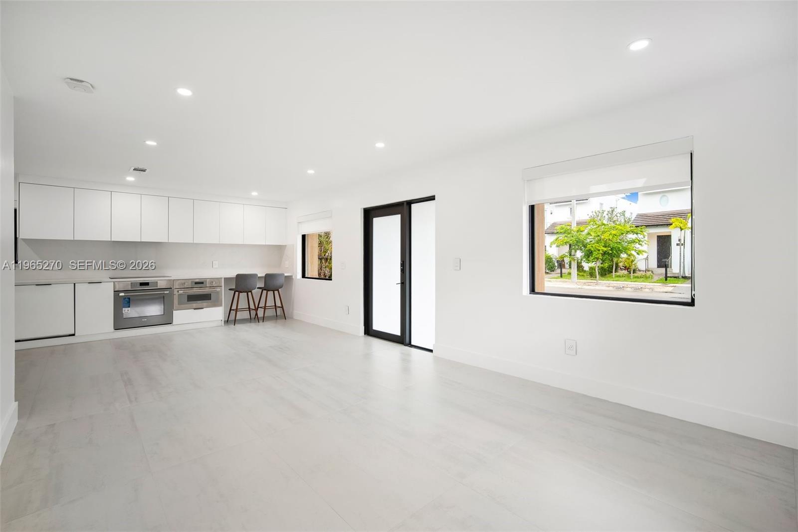 3668 Southwest 26th Street Miami, FL 33133 - Photo 5 of 16 a view of an empty room with a window