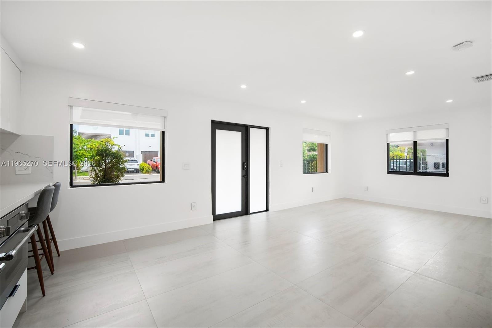 3668 Southwest 26th Street Miami, FL 33133 - Photo 6 of 16 a view of an empty room with a window