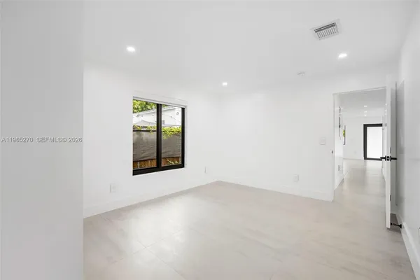 an empty room with windows and entrance