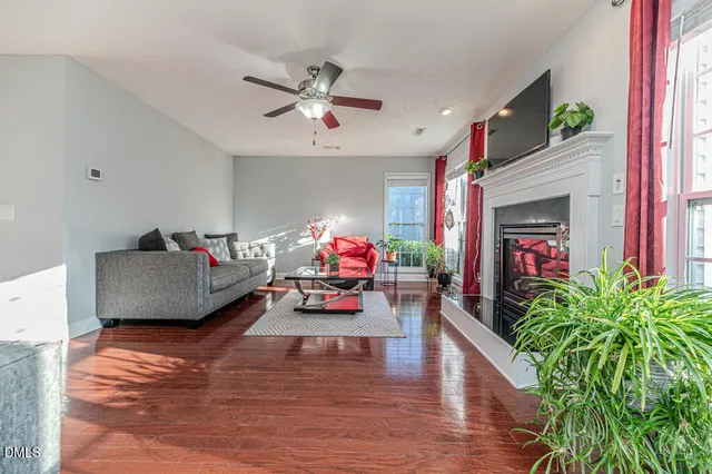 a living room with furniture a flat screen tv and a fireplace