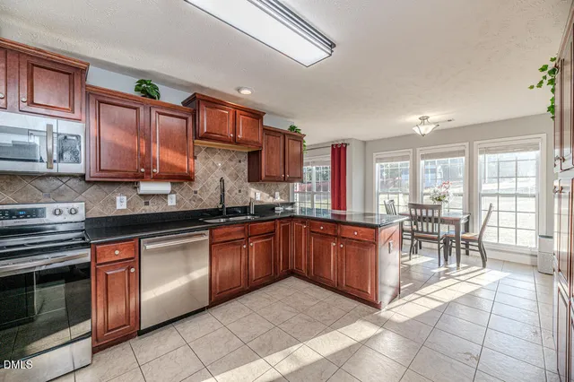 a living room with furniture and a ceiling fan