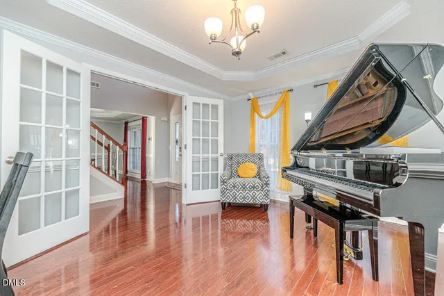 a view of a hallway with furniture and wooden floor