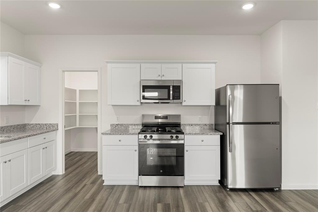 1324 Kennedy Road Howe, TX 75459 - Photo 11 of 29 a kitchen with a stove a refrigerator and a microwave