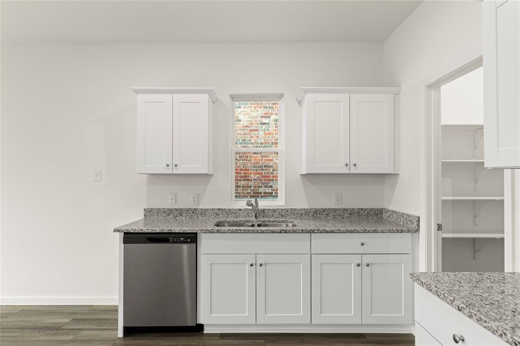 1324 Kennedy Road Howe, TX 75459 - Photo 12 of 29 a kitchen with granite countertop white cabinets and a sink