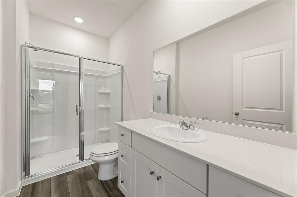 1324 Kennedy Road Howe, TX 75459 - Photo 19 of 29 a bathroom with a shower sink vanity mirror and toilet